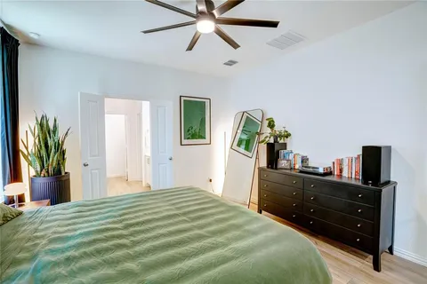 a bedroom with a bed and ceiling fan