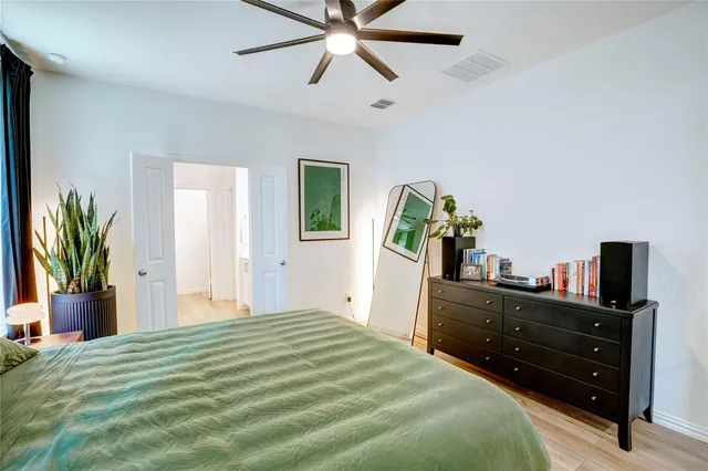 a bedroom with a bed and ceiling fan