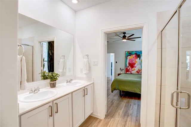 a en suite bathroom with a double vanity sink and a mirror