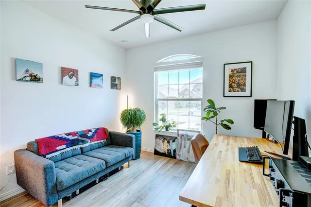 a view of a workspace with furniture and a window