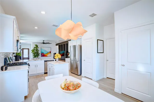 a kitchen with a table and chairs
