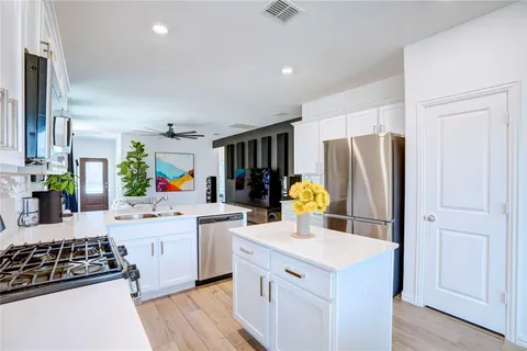 a kitchen with a stove a refrigerator and a sink