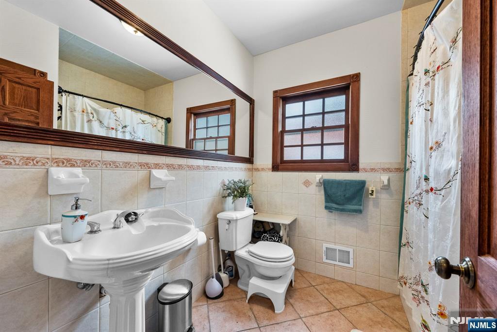 127 Hillside Avenue Cresskill, NJ 07626 - Photo 10 of 42 a bathroom with a sink toilet and shower