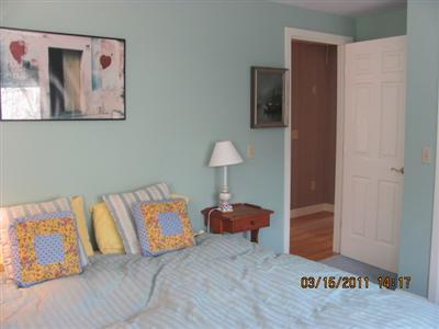 25 Battlefield Road Chatham, MA 02633 - Photo 15 of 16 a bedroom with a bed and painting on the wall