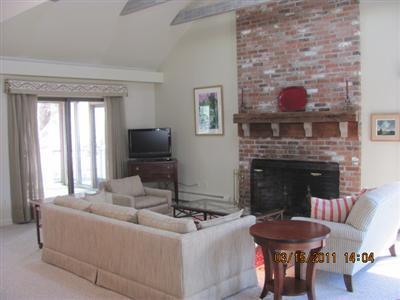25 Battlefield Road Chatham, MA 02633 - Photo 6 of 16 a living room with furniture a flat screen tv and a fireplace