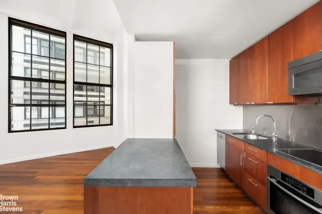 a kitchen with granite countertop a refrigerator and a stove