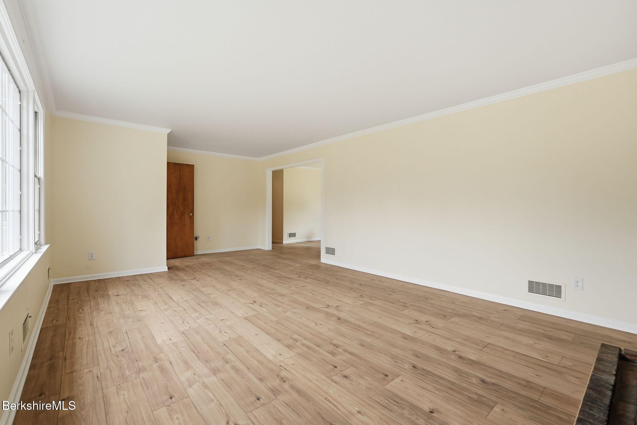 98 N Road Monroe, MA 01247 - Photo 10 of 32 an empty room with wooden floor and windows