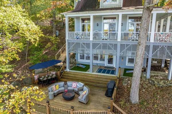 a view of a patio with couches chairs and wooden floor