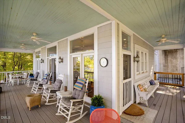 a view of a roof deck with couches and wooden floor