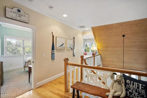 a living room with furniture kitchen view and a wooden floor