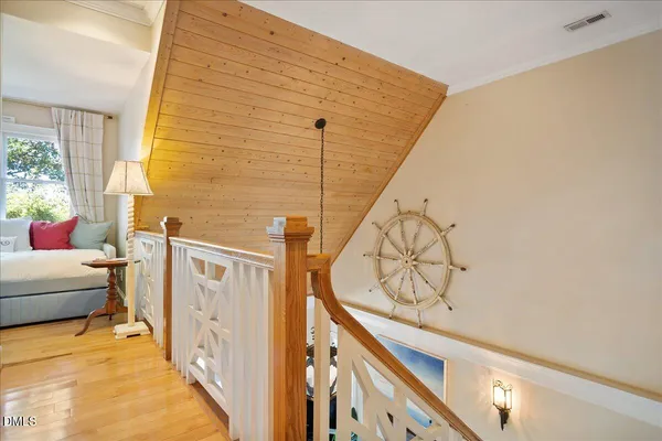 a bedroom with a bed a chair and a large window