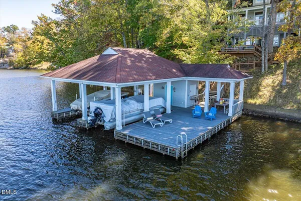 a view of a house with pool and chairs