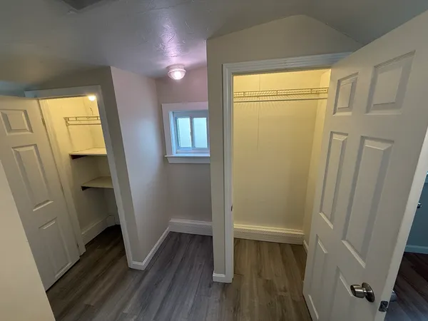 a view of room with window and wooden floor