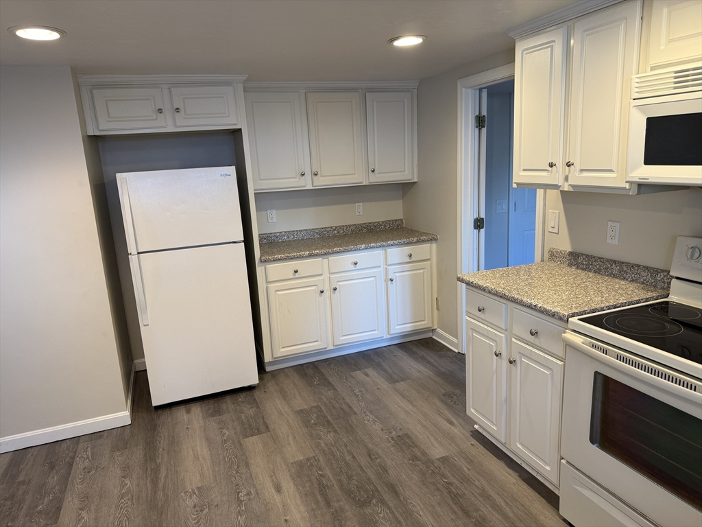 6 Ninth Street, Unit 1 Wareham, MA 02558 - Photo 15 of 15 a kitchen with granite countertop white cabinets and white appliances