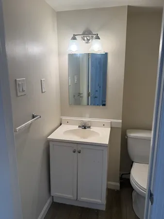 a bathroom with a toilet sink and mirror