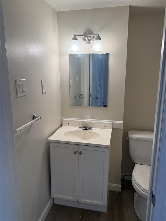 6 Ninth Street, Unit 1 Wareham, MA 02558 - Photo 7 of 15 a bathroom with a toilet sink and mirror