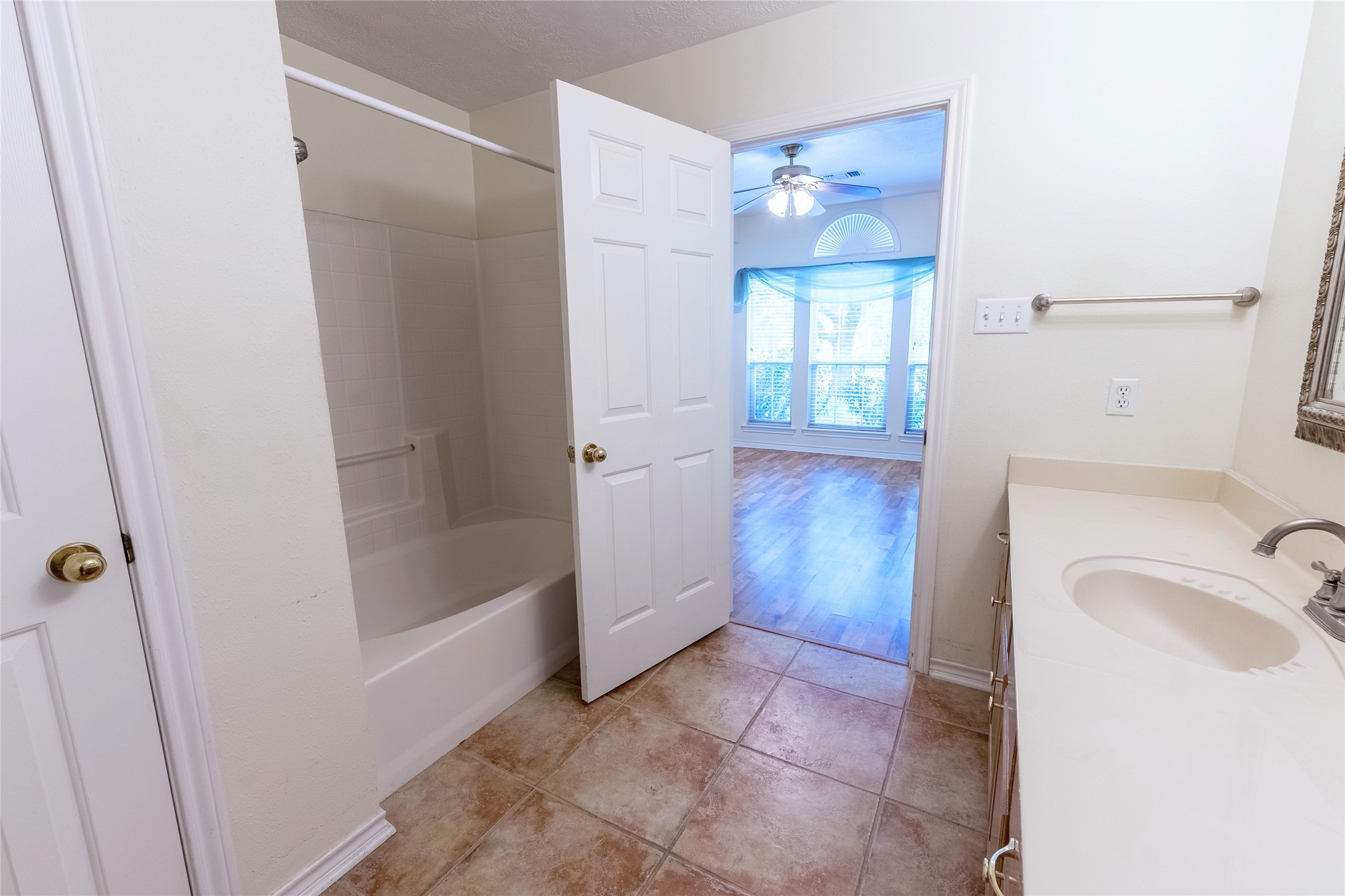 4802 Treadgold Lane Bryan, TX 77802 - Photo 18 of 27 a bathroom with a tub shower and sink