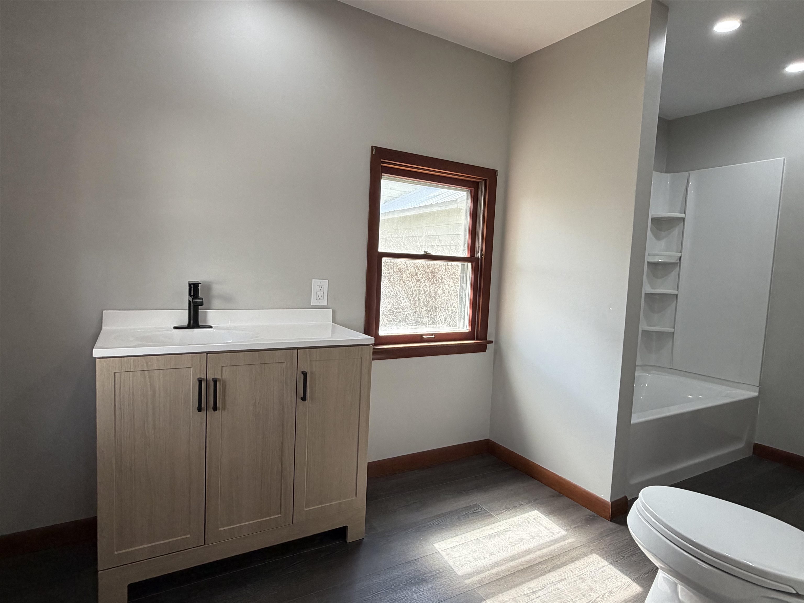 8415 Ravere Street Machesney Park, IL 61115 - Photo 13 of 19 a bathroom with a sink a toilet and a window