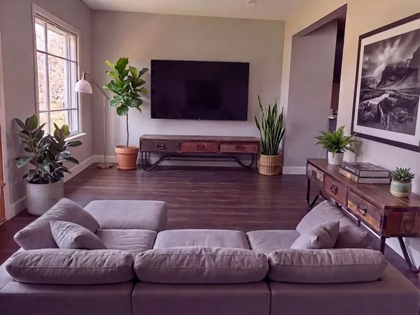 a living room with furniture potted plant and a window