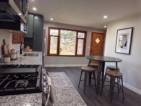 a kitchen with a table and chairs in it