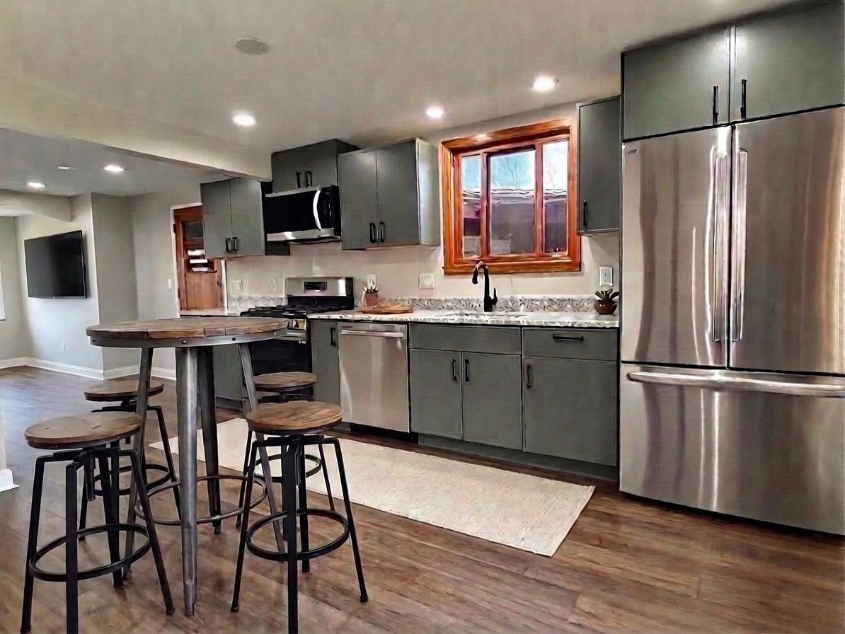 8415 Ravere Street Machesney Park, IL 61115 - Photo 10 of 19 a kitchen with stainless steel appliances granite countertop a refrigerator a sink a stove a dining table and chairs