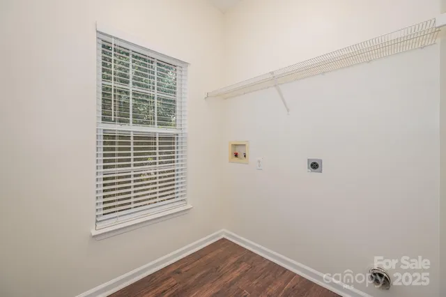 a view of a room that has a window and wooden floor