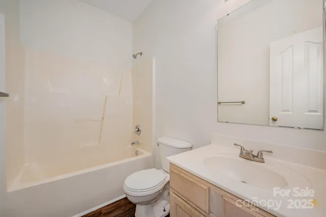 a bathroom with a sink toilet vanity and bathtub