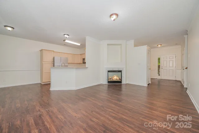 a view of a kitchen with a sink and a refrigerator