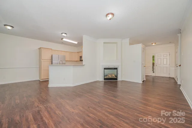 a view of a kitchen with a sink and a refrigerator