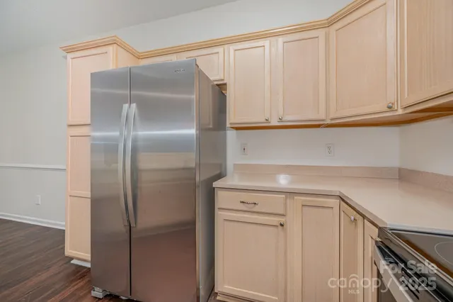 a kitchen with metallic refrigerator and cabinets