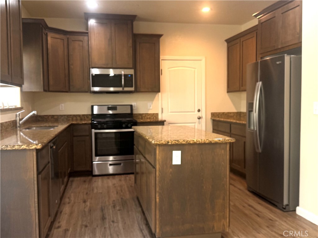 1339 Playa Del Rey Drive Merced, CA 95348 - Photo 10 of 48 a kitchen with stainless steel appliances granite countertop a stove a sink and a refrigerator