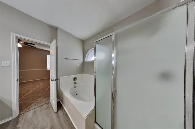 a bathroom with a tub and shower