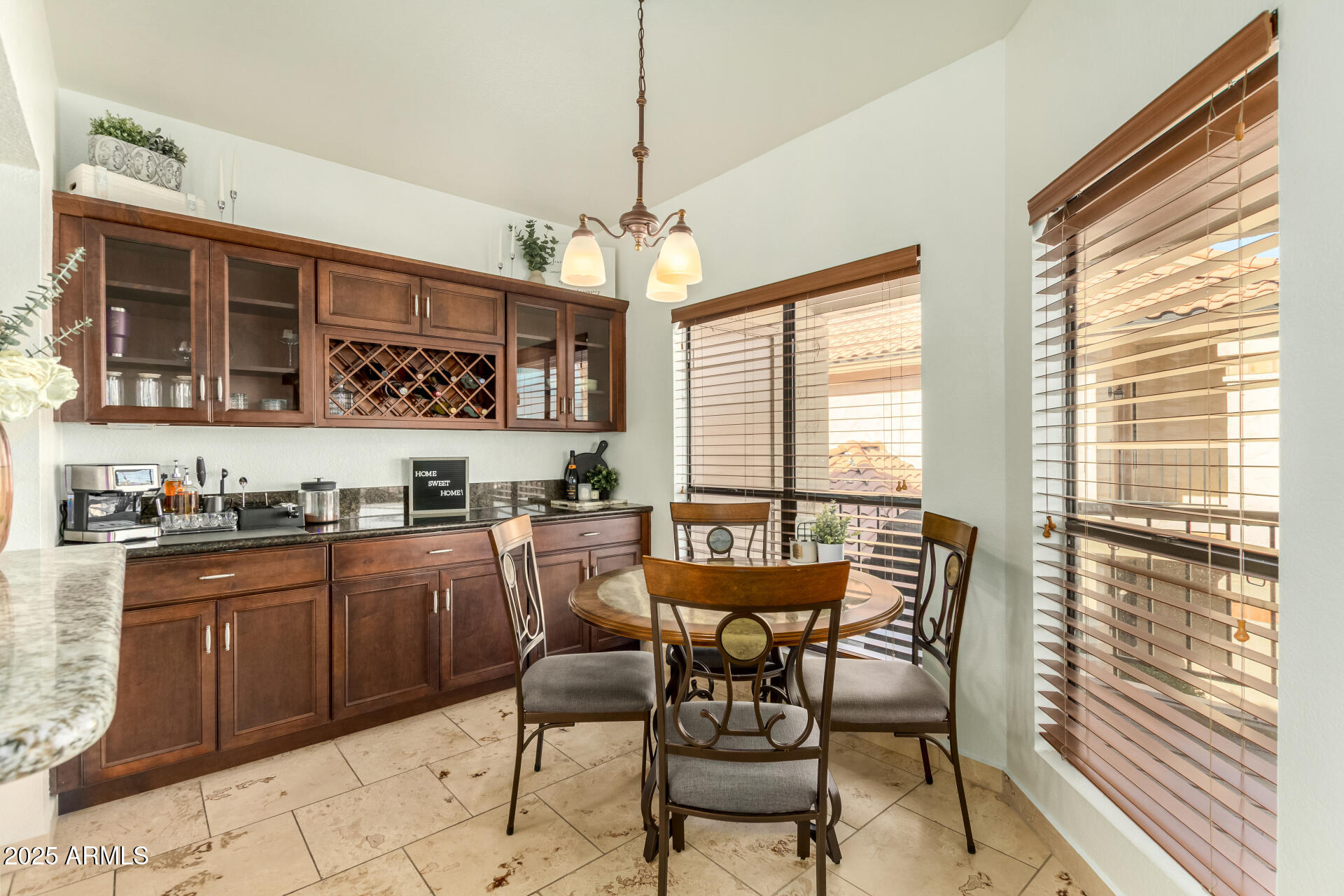 9711 East Mountain View Road, Unit 2514 Scottsdale, AZ 85258 - Photo 11 of 26 a kitchen with stainless steel appliances granite countertop wooden cabinets a stove a sink a dining table and chairs