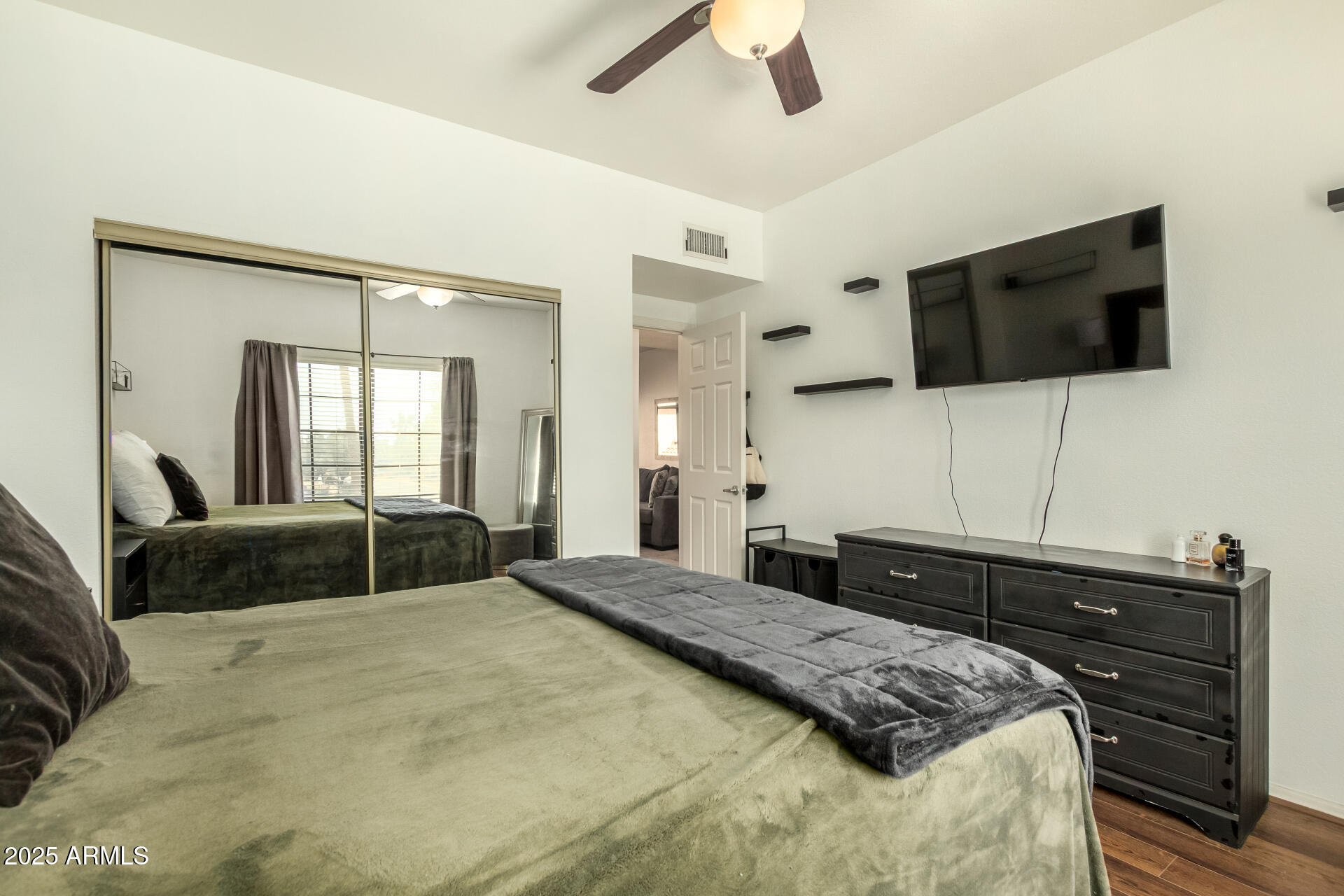 9711 East Mountain View Road, Unit 2514 Scottsdale, AZ 85258 - Photo 15 of 26 a bedroom with a large bed and a flat screen tv
