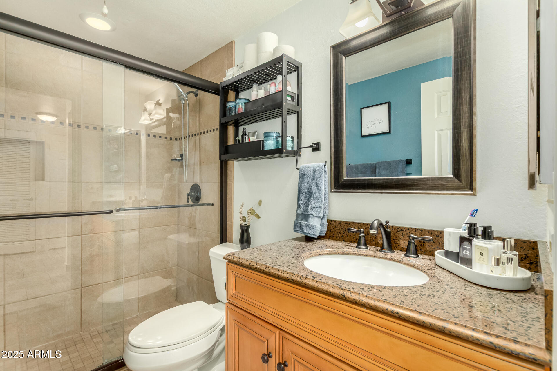 9711 East Mountain View Road, Unit 2514 Scottsdale, AZ 85258 - Photo 16 of 26 a bathroom with a granite countertop sink toilet a mirror and shower