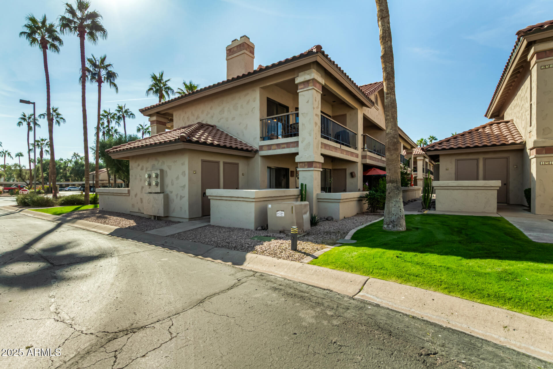 9711 East Mountain View Road, Unit 2514 Scottsdale, AZ 85258 - Photo 23 of 26 a front view of a house with a garden and yard