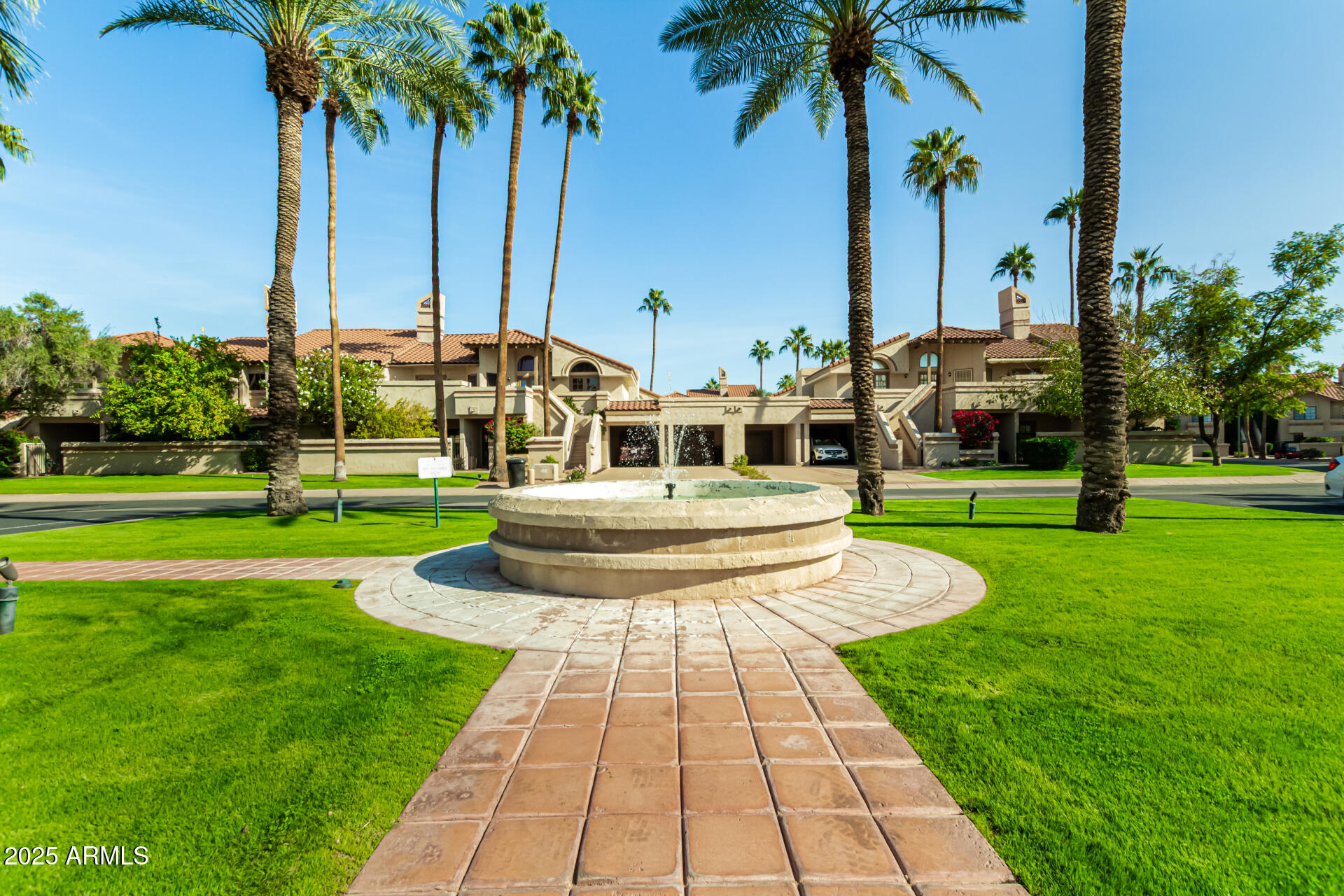 9711 East Mountain View Road, Unit 2514 Scottsdale, AZ 85258 - Photo 24 of 26 a front view of multi story residential apartment building with yard and green space