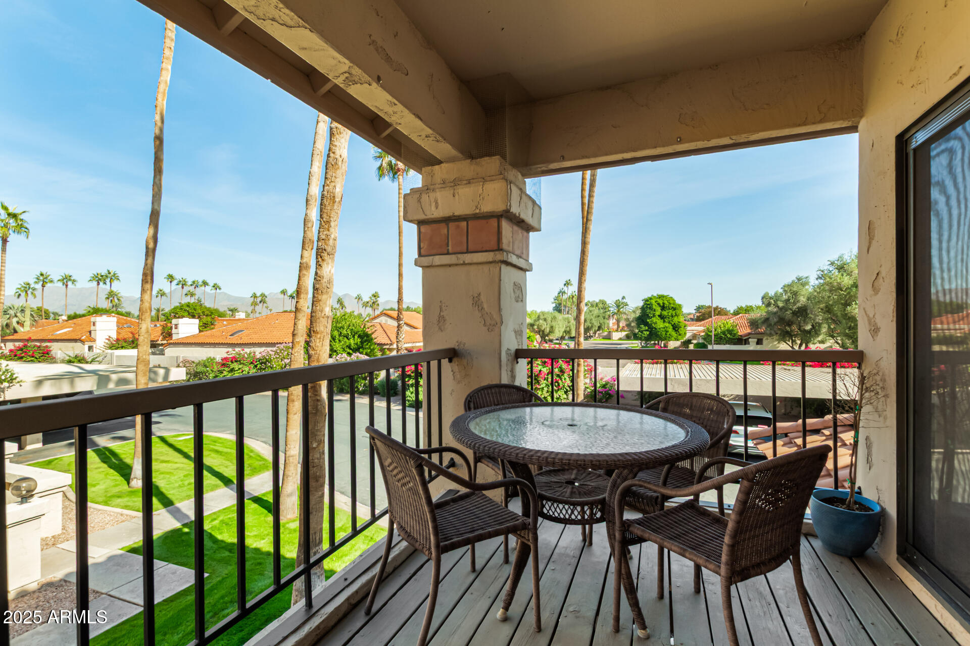 9711 East Mountain View Road, Unit 2514 Scottsdale, AZ 85258 - Photo 3 of 26 a view of a balcony with a table and chairs