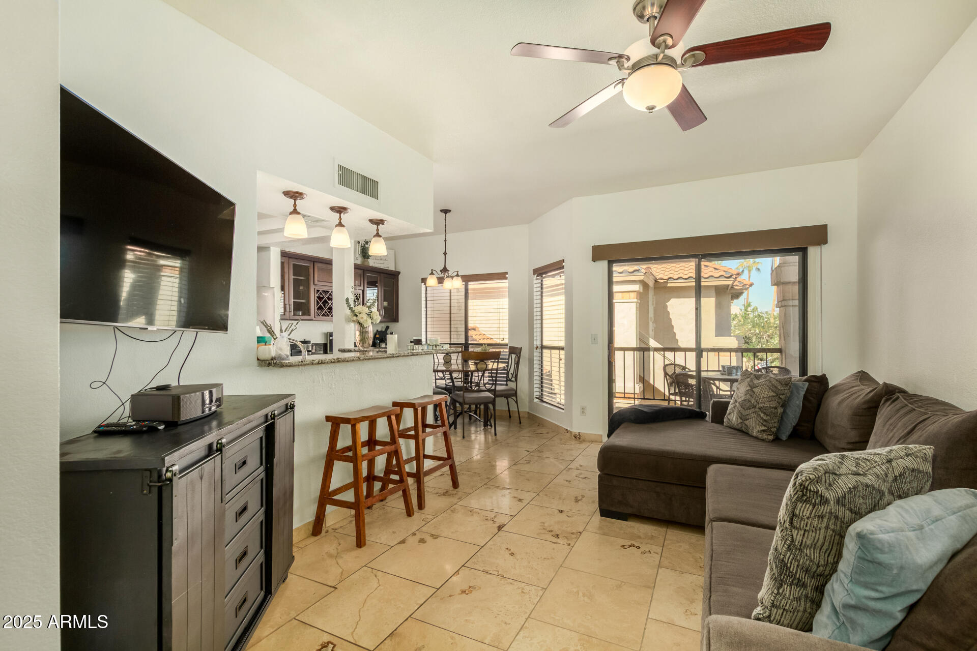 9711 East Mountain View Road, Unit 2514 Scottsdale, AZ 85258 - Photo 5 of 26 a living room with furniture and a flat screen tv