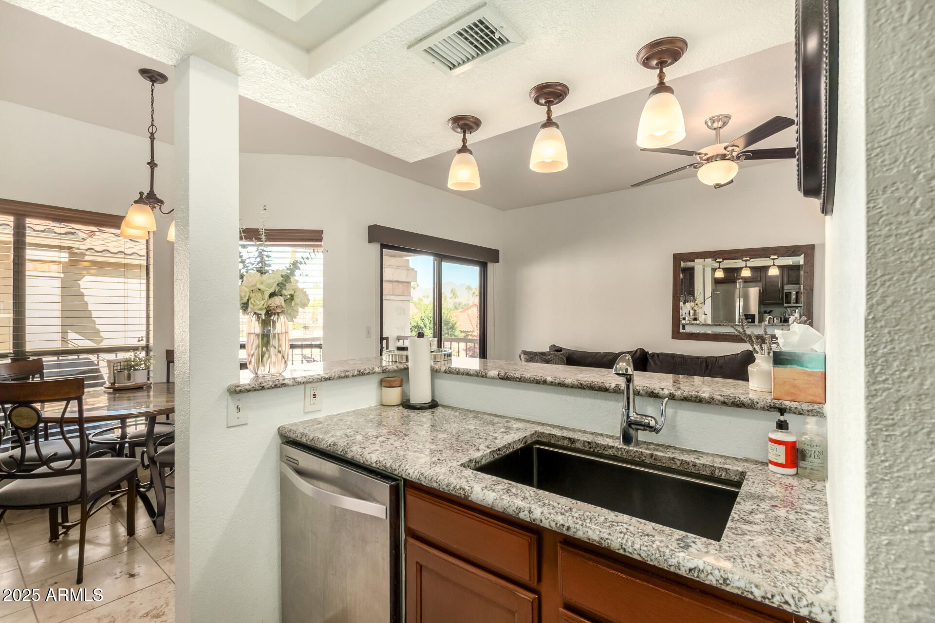 9711 East Mountain View Road, Unit 2514 Scottsdale, AZ 85258 - Photo 7 of 26 a kitchen with granite countertop a sink a stove and cabinets