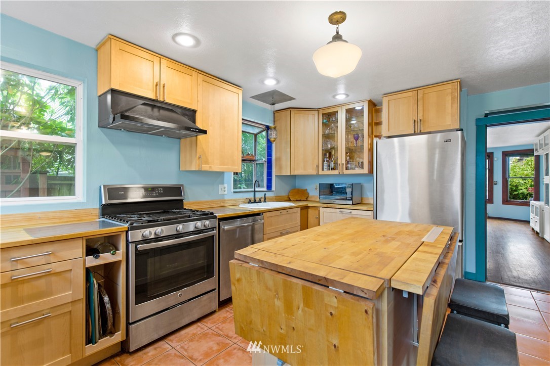 907 North 68th Street Seattle, WA 98103 - Photo 12 of 36 a kitchen with a stove and a refrigerator