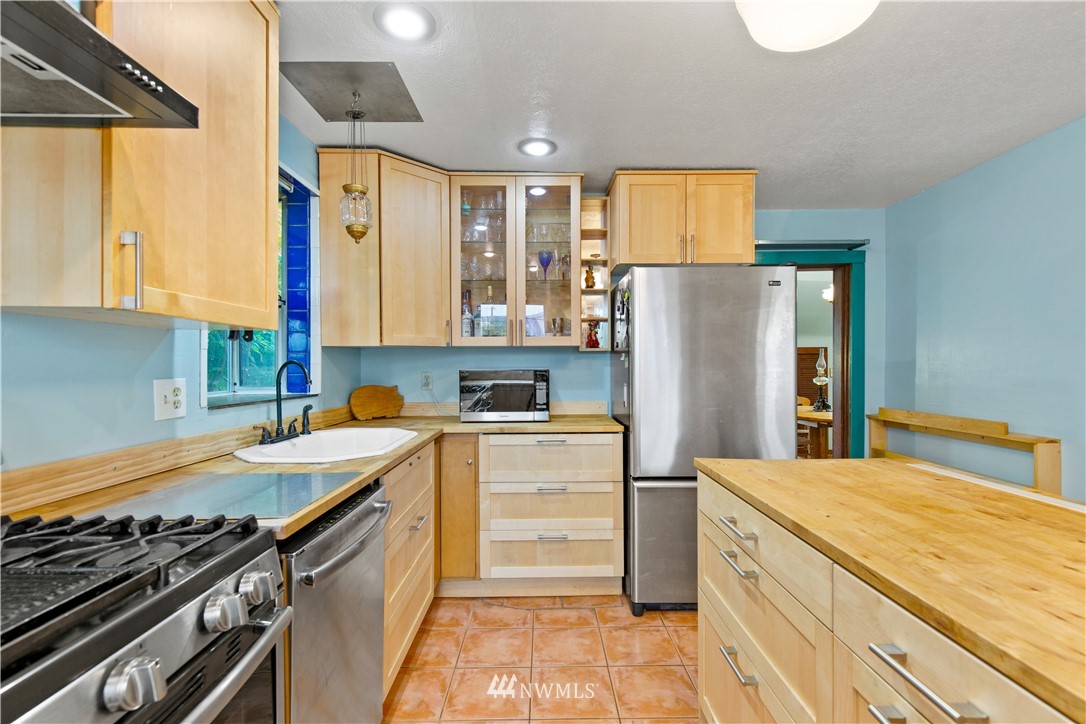 907 North 68th Street Seattle, WA 98103 - Photo 13 of 36 a kitchen with a refrigerator and a sink