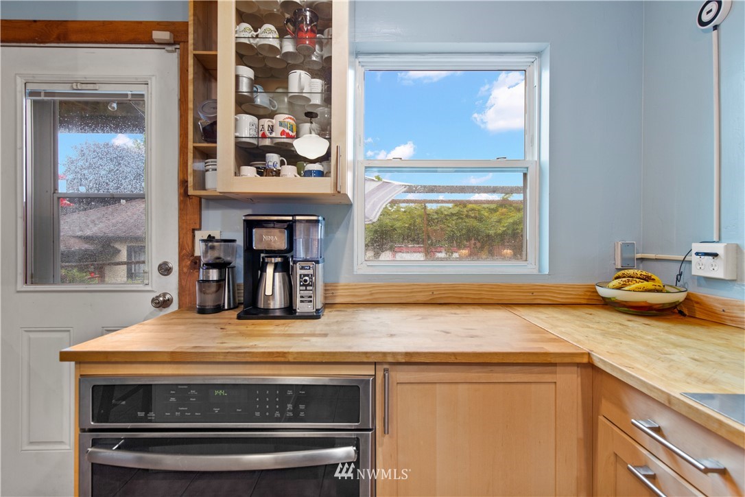 907 North 68th Street Seattle, WA 98103 - Photo 15 of 36 a kitchen with granite countertop a stove and a sink