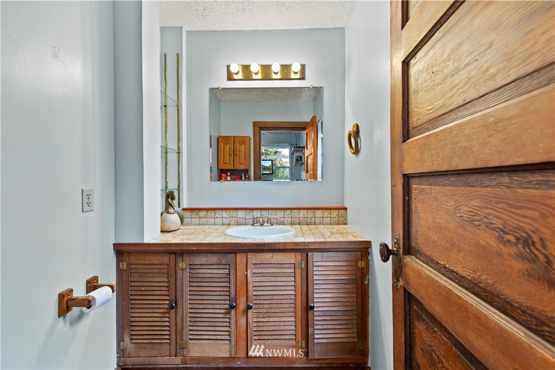 907 North 68th Street Seattle, WA 98103 - Photo 19 of 36 a view of a bathroom with a sink and a mirror