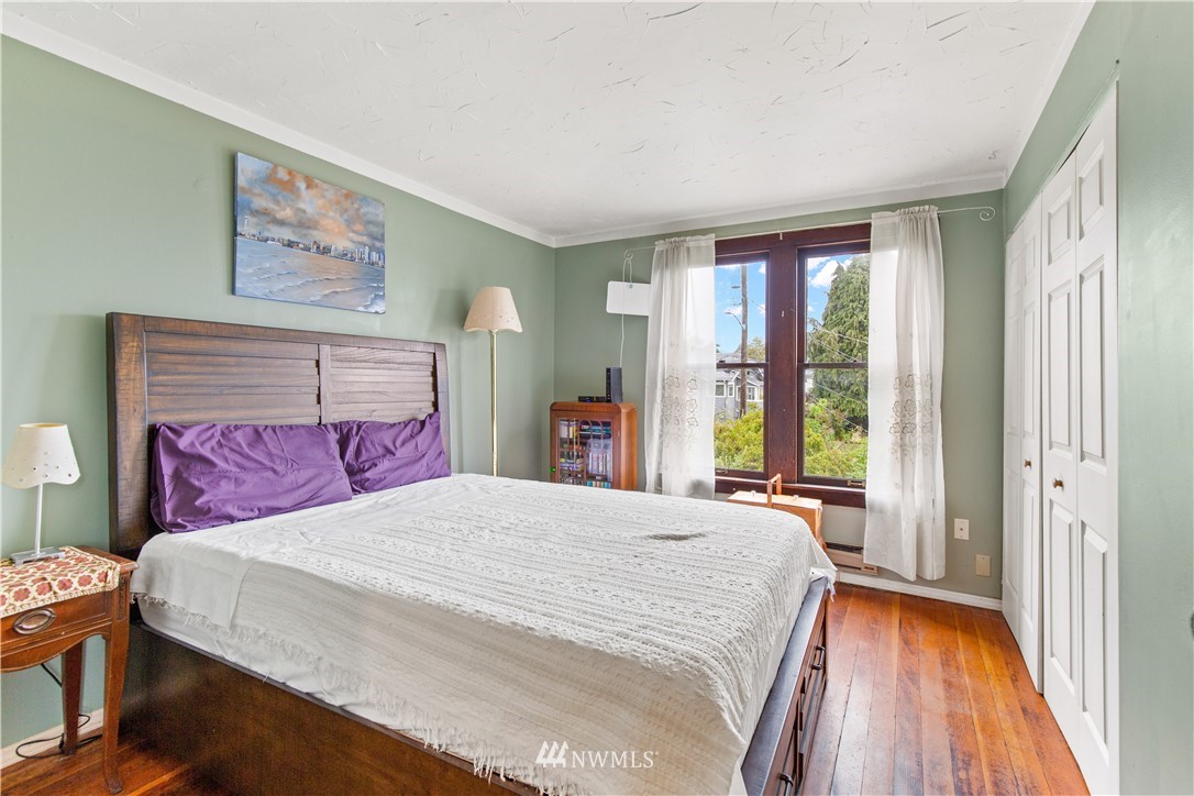 907 North 68th Street Seattle, WA 98103 - Photo 20 of 36 a spacious bedroom with a bed and a large window