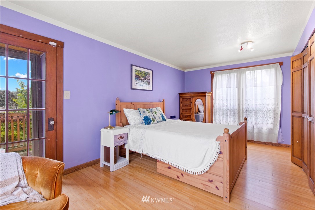 907 North 68th Street Seattle, WA 98103 - Photo 23 of 36 a bedroom with furniture and wooden floor