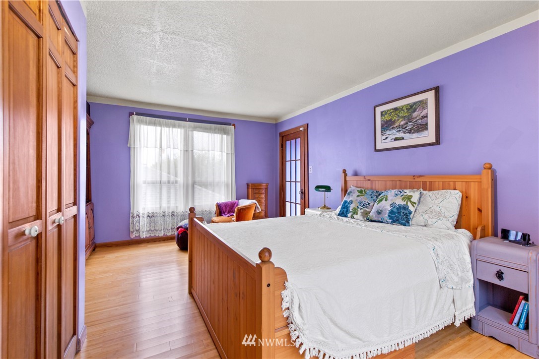 907 North 68th Street Seattle, WA 98103 - Photo 24 of 36 a bedroom with a bed and a large window