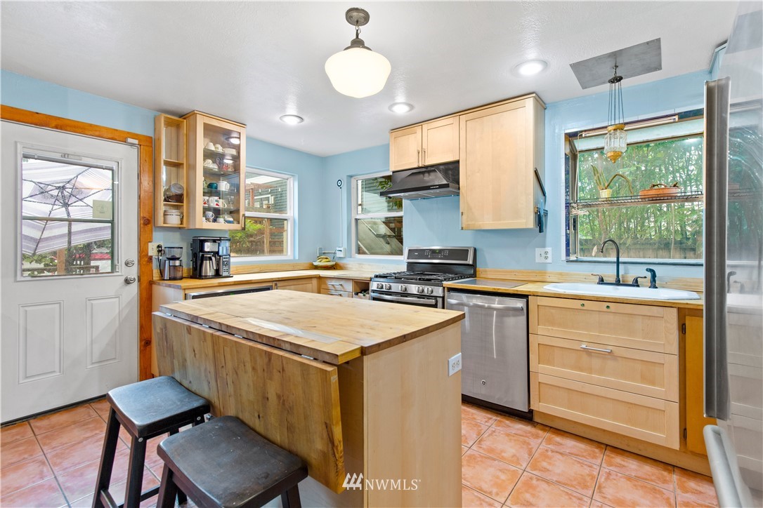 907 North 68th Street Seattle, WA 98103 - Photo 10 of 36 a kitchen with a stove a sink and a refrigerator