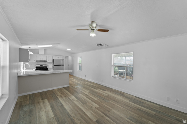 2600 North Hill Field Road, Unit 103A Layton, UT 84041 - Photo 5 of 31 Open-concept living space featuring wood-finish flooring, a contemporary ceiling fan, and white walls