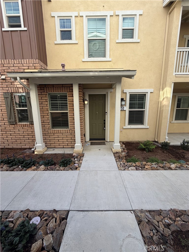 a view of a brick house with a yard